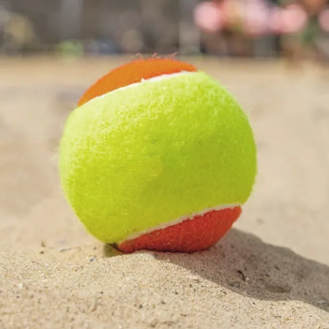 Beach tennis ball on sand